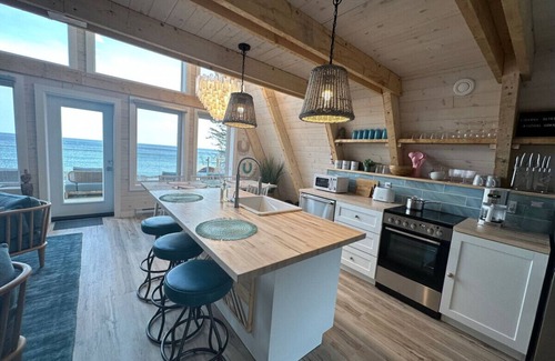 Aspy Bay House | Mystical Beachfront Chalet , Hot tub , Sauna and Heated Container Pool