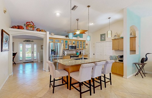 Long Meadow House | Nautical charmer on the canal with heated pool, sunny lanai, grill, W/D, and AC