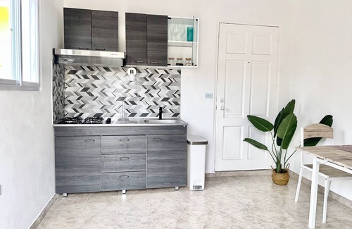 Oranjestad Apartment | New Modern 1B Apt Kitchen & TV