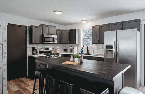 Grawn House | Pet-friendly home with fenced-in yard and hot tub