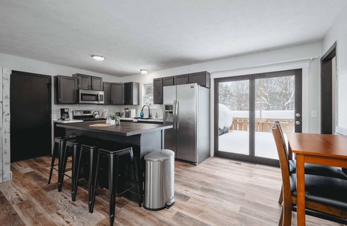 Grawn House | Pet-friendly home with fenced-in yard and hot tub