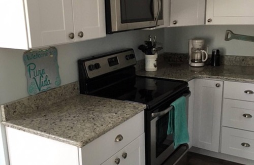 Ocean Pines Cottage | Pura Vida.Canal front beach cottage with private dock and sleeps 8