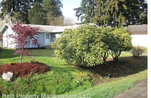 Tracyton House | Single Level home, fenced yard, and a garage