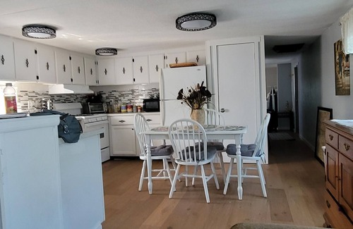Kiteley House | Spacious mobile home with large kitchen/living area and porch with barbeque.