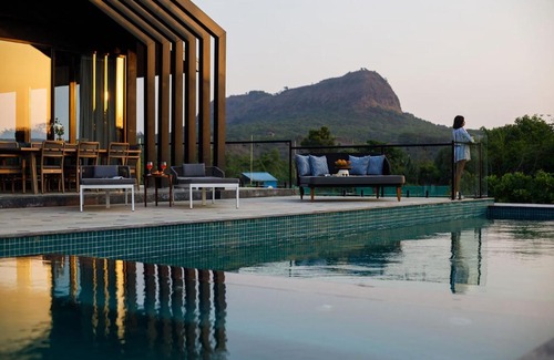 Lonavala Villa | StayVista's The Barn - Mountain-View Luxury Mansion with Heated Infinity Pool, Deck, Jacuzzi, Lawn featuring a Gazebo and Firepit