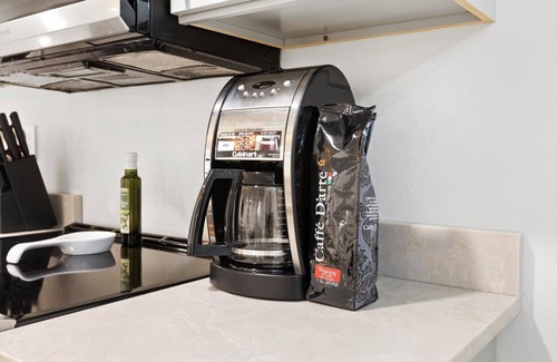 Shoreline Apartment | Step Into Retro Chic: Luxurious Suite King Bed