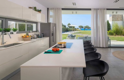 Soroni Villa | Stunning beachfront retreat, private tennis court & infinity pool