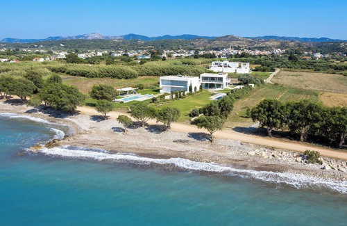 Soroni Villa | Stunning beachfront retreat, private tennis court & infinity pool