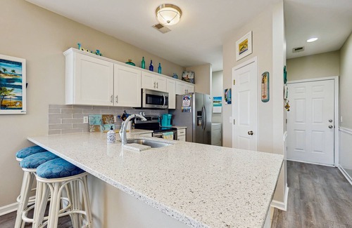 Sunset Beach Apartment | Stunning coastal condo with shared pool, close to beach and local attractions