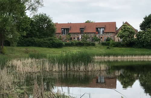 Hirschfelde House | Stylishly furnished fieldstone barn with dining room and terrace by the village pond