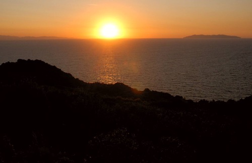 Zanca House | Sunset over Corsica. Detached house surrounded by greenery, sea view.
