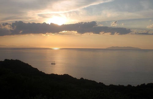 Zanca House | Sunset over Corsica. Detached house surrounded by greenery, sea view.