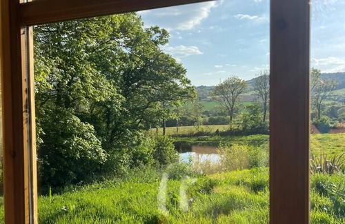 Bridport Cabin | Swimming lake coast close cosy self contained hobbit house amazing walks &views,