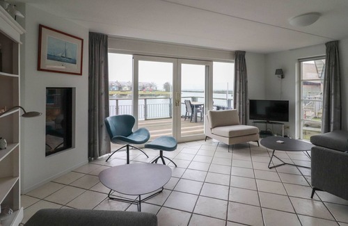 Makkum Villa | Thatched villa with terrace on the water at a holiday park in Friesland