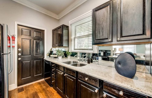 Old East Dallas Condo | The main living area includes a spacious living room, dining area, and spa-inspired bathroom. Guests enjoy complimentary high-speed WiFi, washer/dryer, and all essential amenities for comfort and convenience.