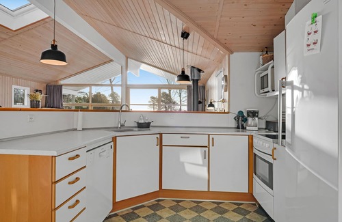 Østerskov House | This beautiful wooden house is located in a smaller cottage area, nestled in beautiful nature.