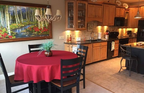 Salida Condo | This riverfront downtown condo boasts and open floor plan for kitchen, living room, and dining areas. Or step onto the balcony over the Arkansas River to hear the water rushing by. Oversized master suite has its own balcony and indoor sitting area.