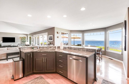 Freeland House | Two-story, bay front retreat with a deck, direct beach access, and washer/dryer