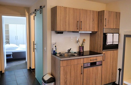 Wremen Apartment | Vacation apartment near the beach with sauna & beautiful, covered balcony with dyke view