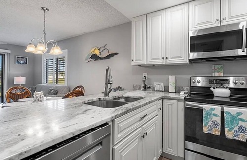 Butler Beach Condo | Walk To The Beach and Restaurants with Pools, Tennis and BBQ