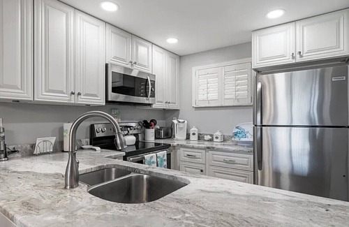 Butler Beach Condo | Walk To The Beach and Restaurants with Pools, Tennis and BBQ