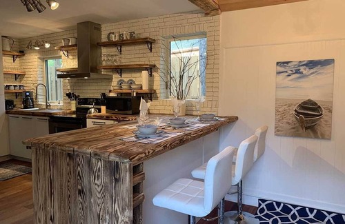 Sainte-Agathe-des-Monts Ski Chalet | Waterfront cottage with private spa, blending rustic and contemporary charm.