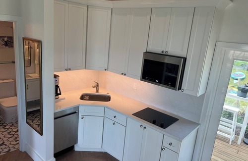 Jensen Beach House | Waterfront luxury bungalow with private beach, paddleboards, kayaks and bikes!