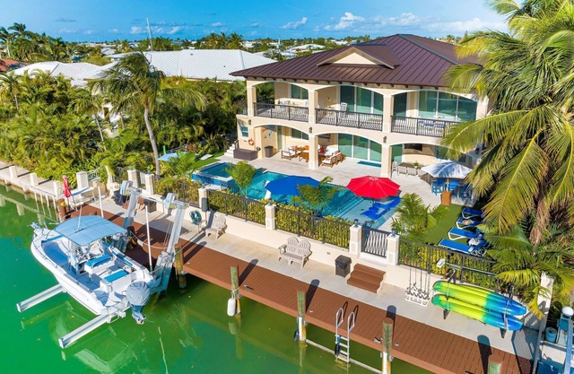 5 bedrooms, pool/spa heated, bikes, kayaks, game room, elevator, deep 75' dock.