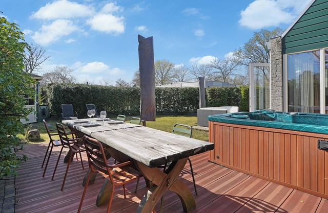A cozy 4-person holiday home at De Klepperstee in Ouddorp by the Sea, featuring a lush garden, full privacy, and a private jacuzzi – all within walking distance of the beach.
