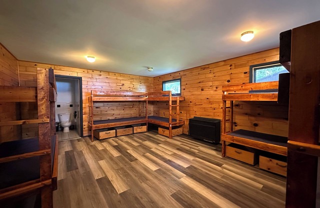 A summer camp cabin with attached bath and lounge area