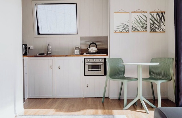 A tiny house with a big section across the road from the beach