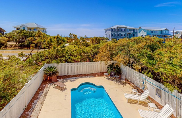 Beach view dog-friendly home with a pool, tennis, fireplace, washer/dryer, grill