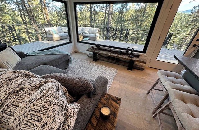 Charming cabin nestled in pine trees and surrounded by beautiful mountains