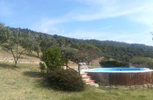 Detached stone view cottage with swimming pool and fenced garden.