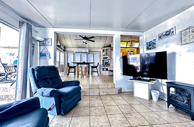 Dog-friendly bayfront home with in/outdoor pools, tennis, gym, W/D, bay views