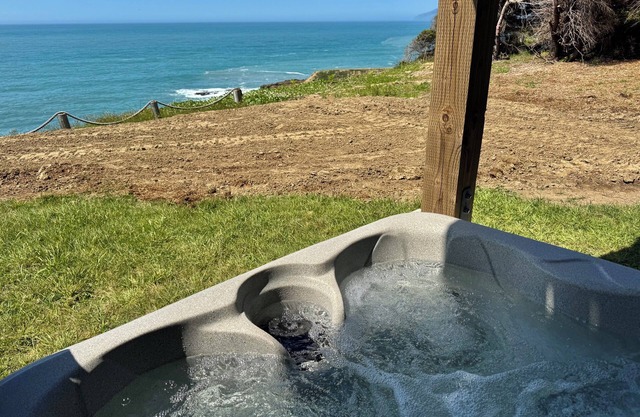 Dolphin by OceanviewHotTubs Tesla charging Oceanfront Shelter Coven
