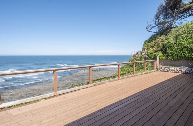 Dramatic oceanfront views. Open high ceilings. Huge deck & walls of windows!