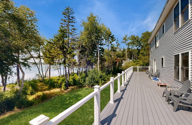 Elegant, spacious coastal home with sunset ocean views from an inviting deck