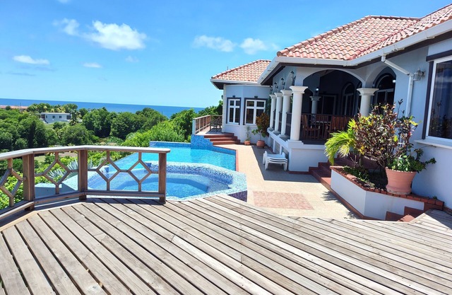 Enjoy the tropical breezes & coral reef views while sitting by the pool!