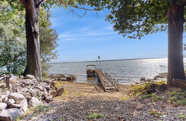 Escape to this spacious lakefront retreat with W/D, AC, firepit, & grill