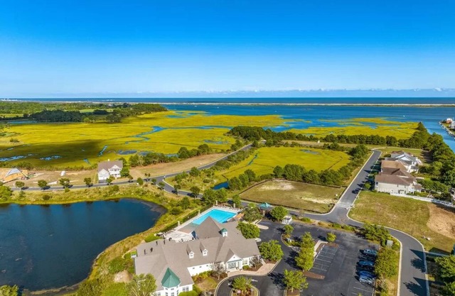 Experience The Beauty & Luxury Of This Townhome Located in A Resort Community