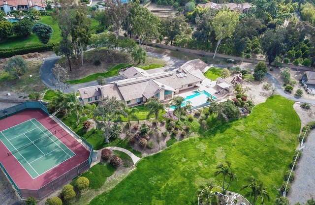 Family ranch w/luxurious pool, spa & landscaping plus horse lodging!