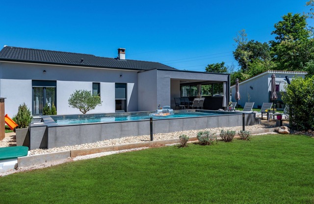 First floor villa with pool, surrounded by greenery