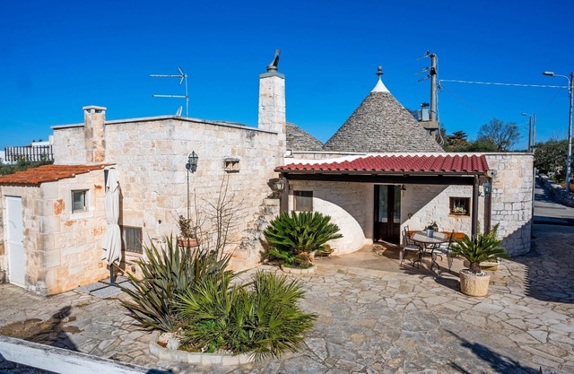 Historic trulli surrounded by ancient olive trees