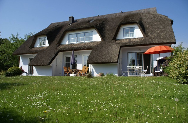 Holiday house thatched with reed in natural reserve area with garden and terrace