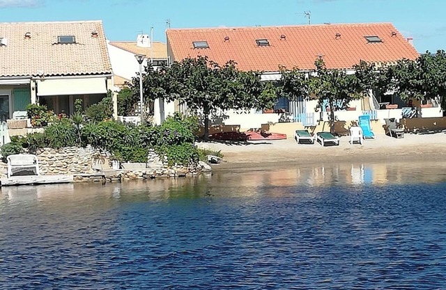 House on the edge of a marine pond close to the beach