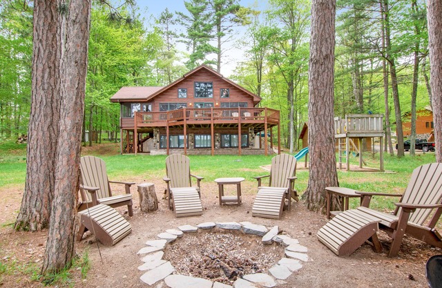 Lakefront dog-friendly home with firepit, play set, dock, & beach access