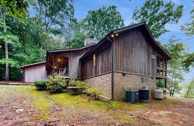 Lakefront home in the woods with dock, den, & private hot tub - dog-friendly