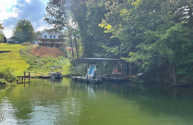 Lakefront home with dock. Cozy 2 bed 2 bath and screened in porch.