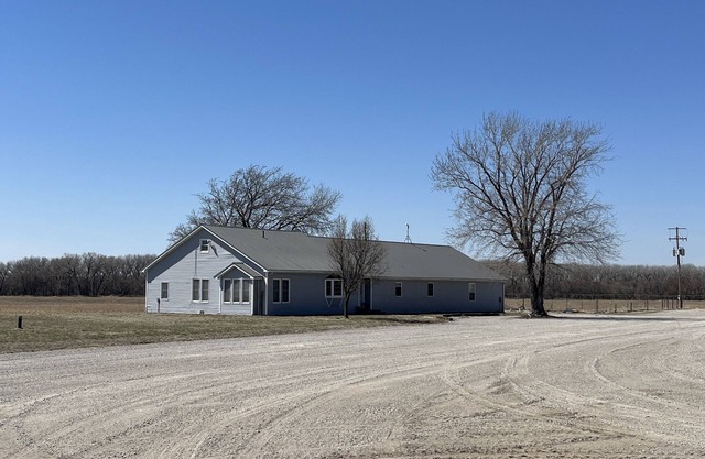 Large house surrounded by farm land along the Republican River.